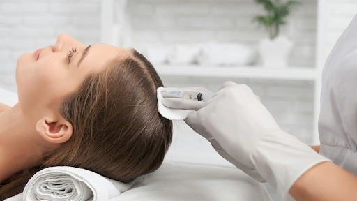 Female patient receiving professional hair restoration treatment for hair loss